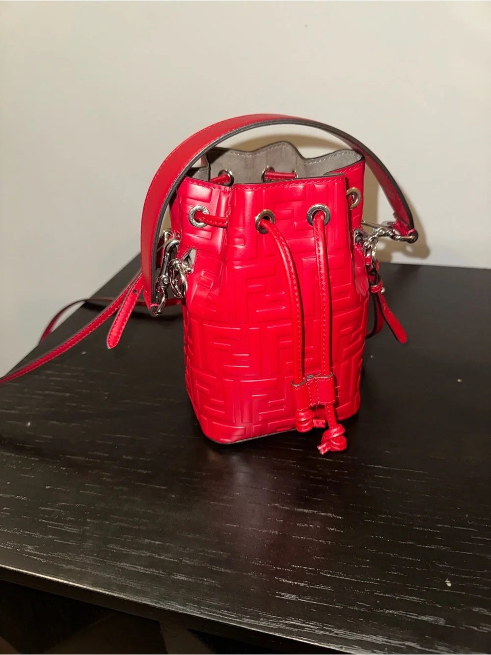 Fendi Mon Tresor mini bucket bag in a vibrant red hue with embossed FF logos
